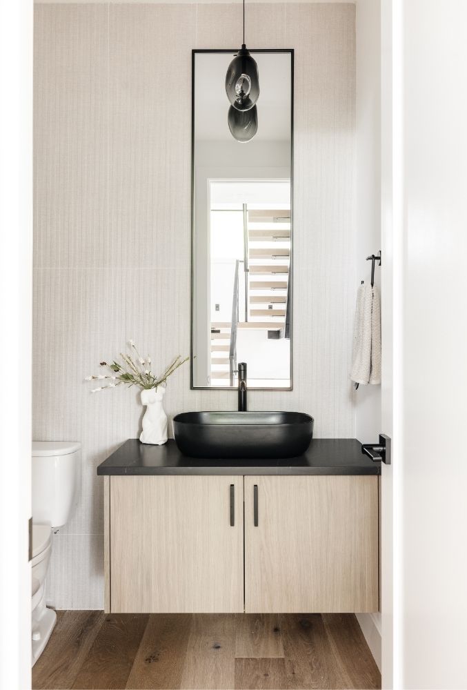 Modern powder room with floating vanity and black vessel sink in Boulder luxury home