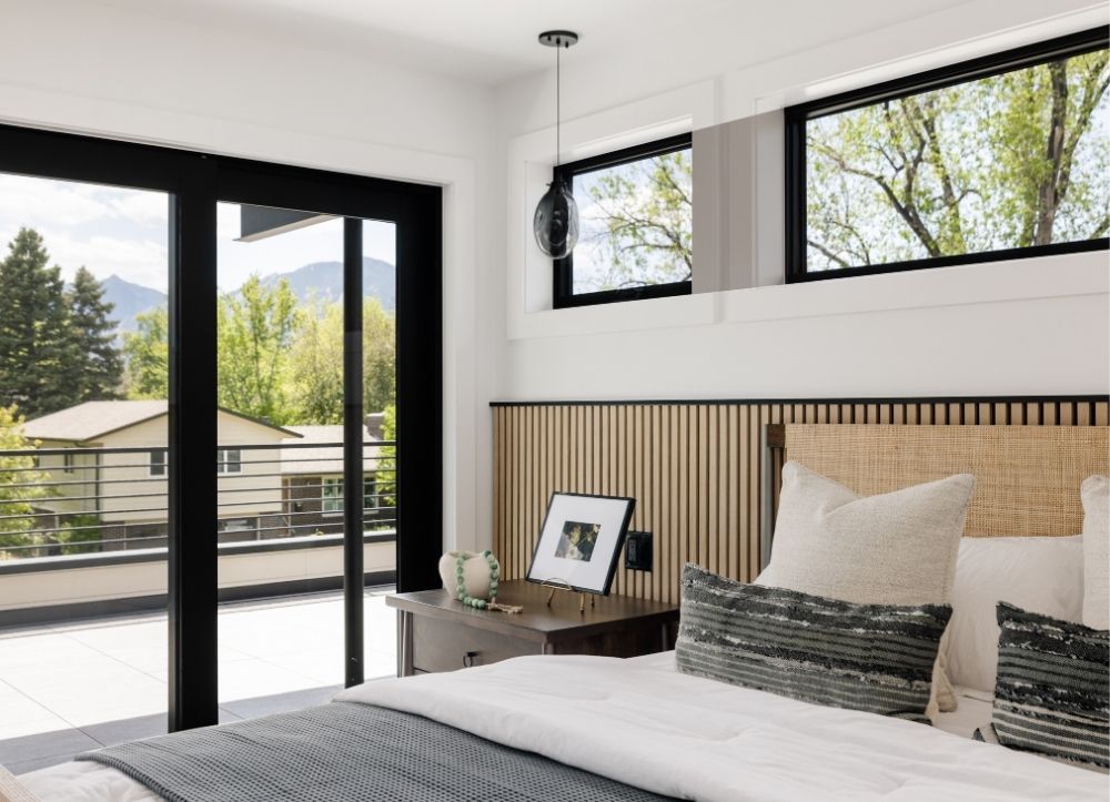 Modern bedroom with wood slat accent wall and mountain views in Boulder Colorado luxury home