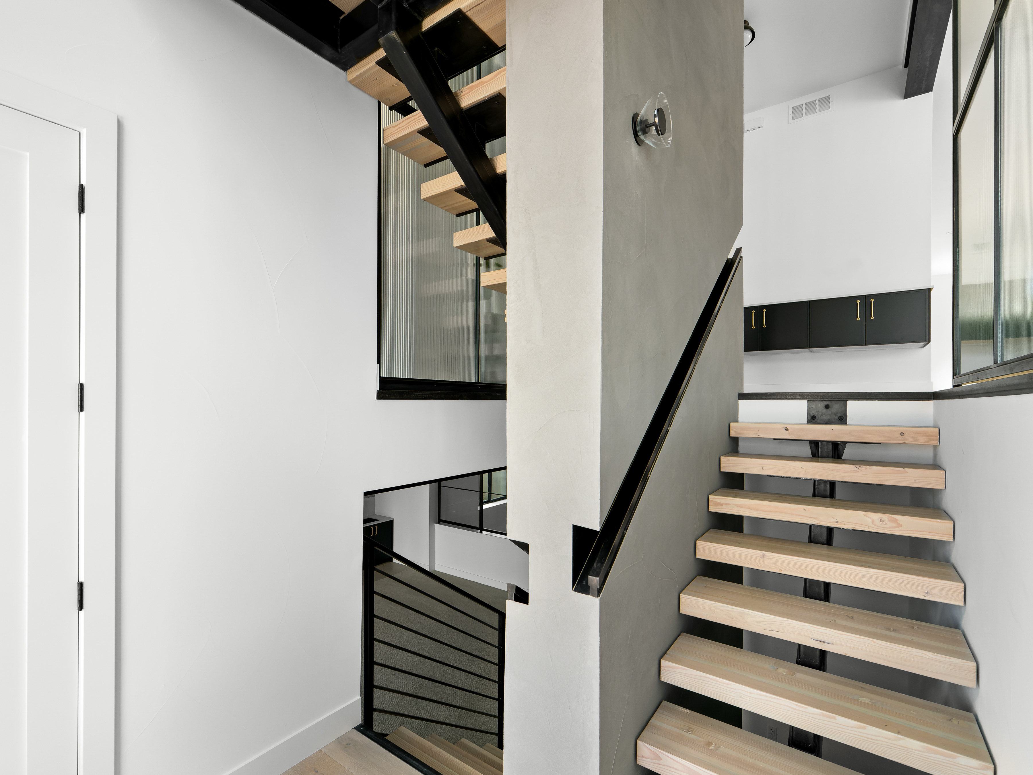 Beautiful wood and steel accented stair well and landing by Work Shop Colorado