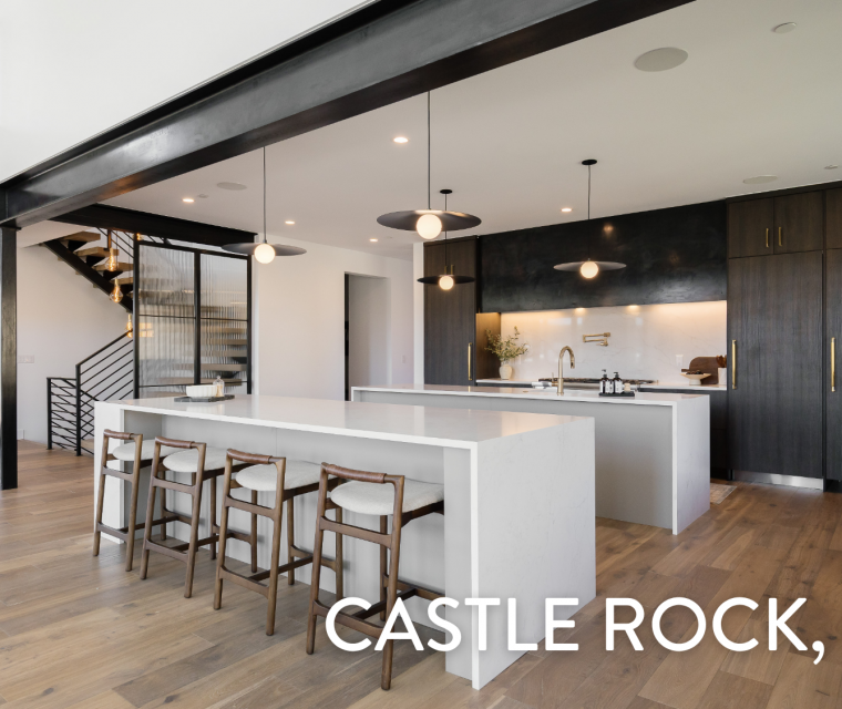 Modern kitchen with dark cabinetry, white waterfall islands, and brass pendant lighting in a luxury home at 5292 Lions Paw St, Castle Rock, CO