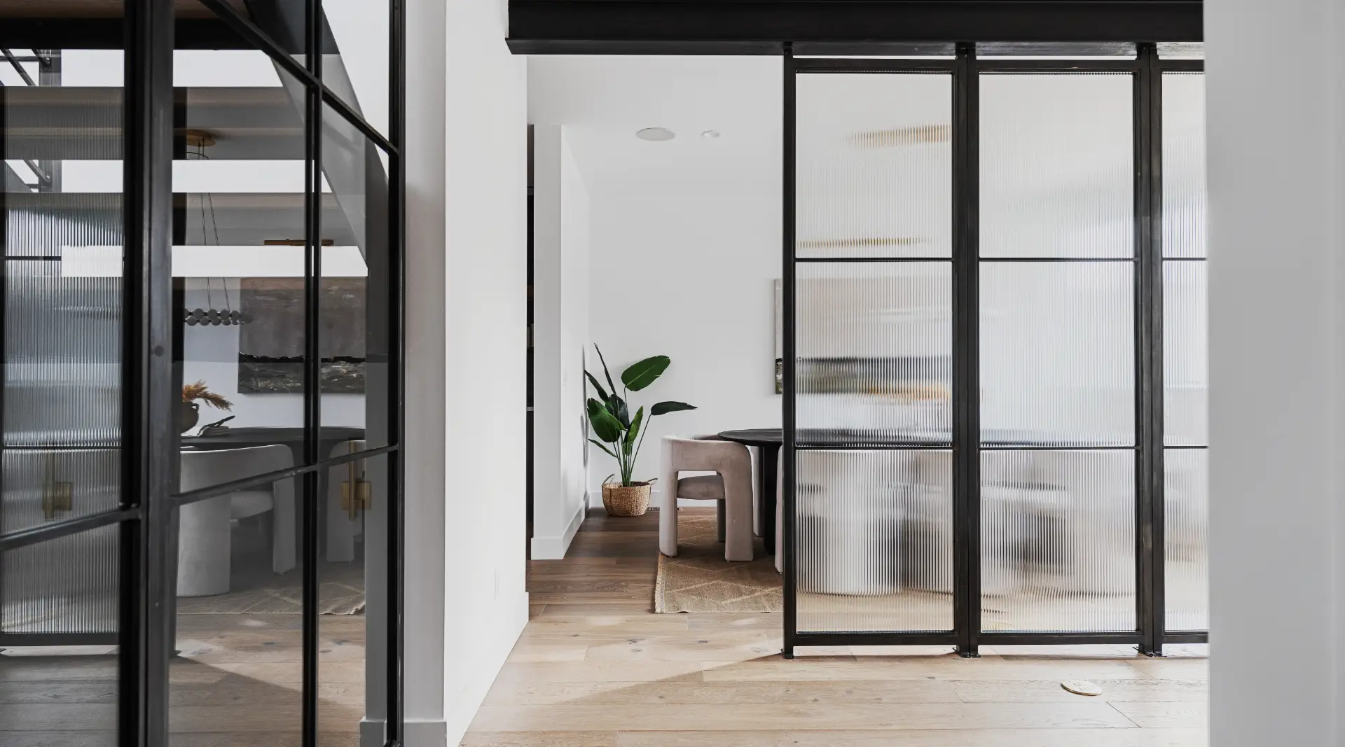 Custom steel and glass partitions in the dining area of a luxury semi-custom new home in Colorado. 