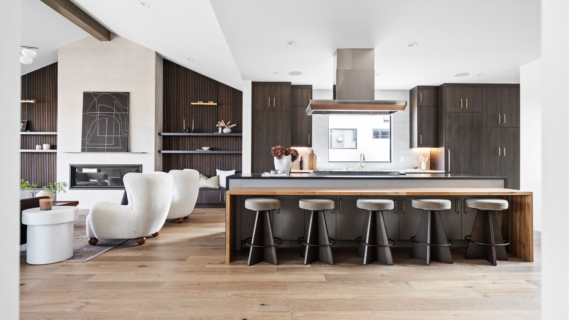 Open-concept kitchen and living area with custom shelving in modern Applewood West home