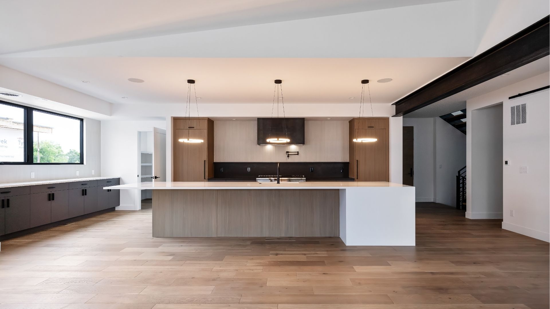 Open-concept kitchen and great room with custom wood cabinetry in luxury Golden Colorado home