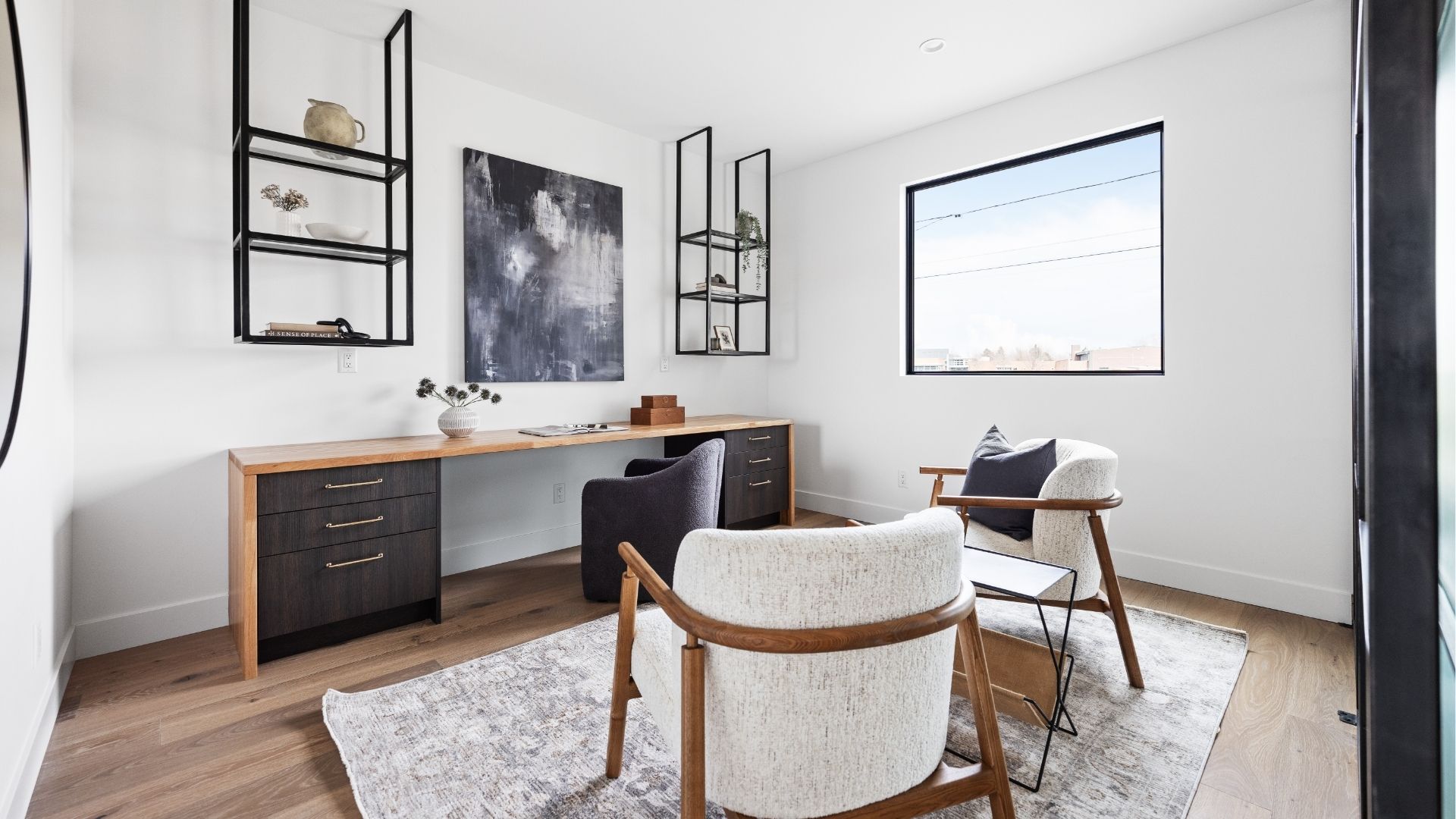 Home office with built-in desk and steel shelving in new construction Golden home