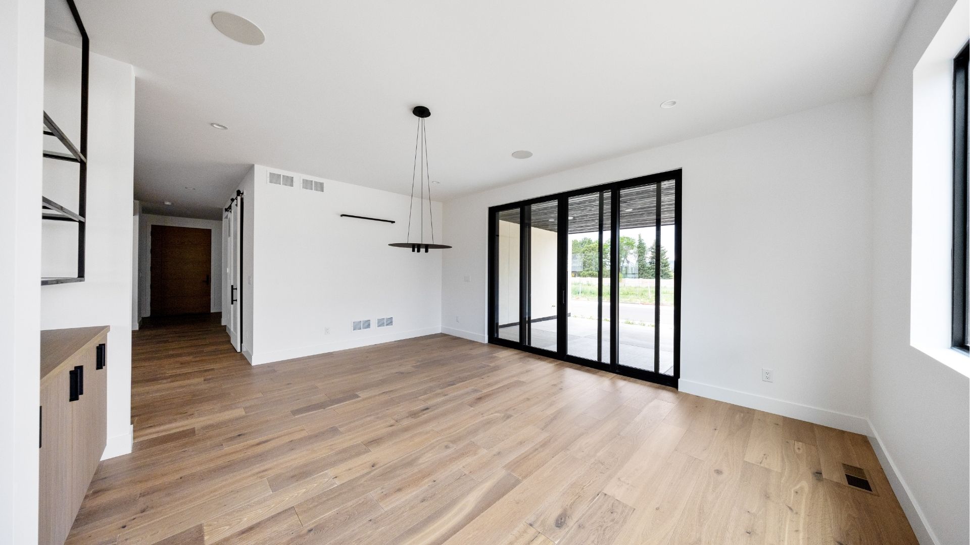 Dining area with sliding glass doors to outdoor deck in move-in ready Golden luxury home