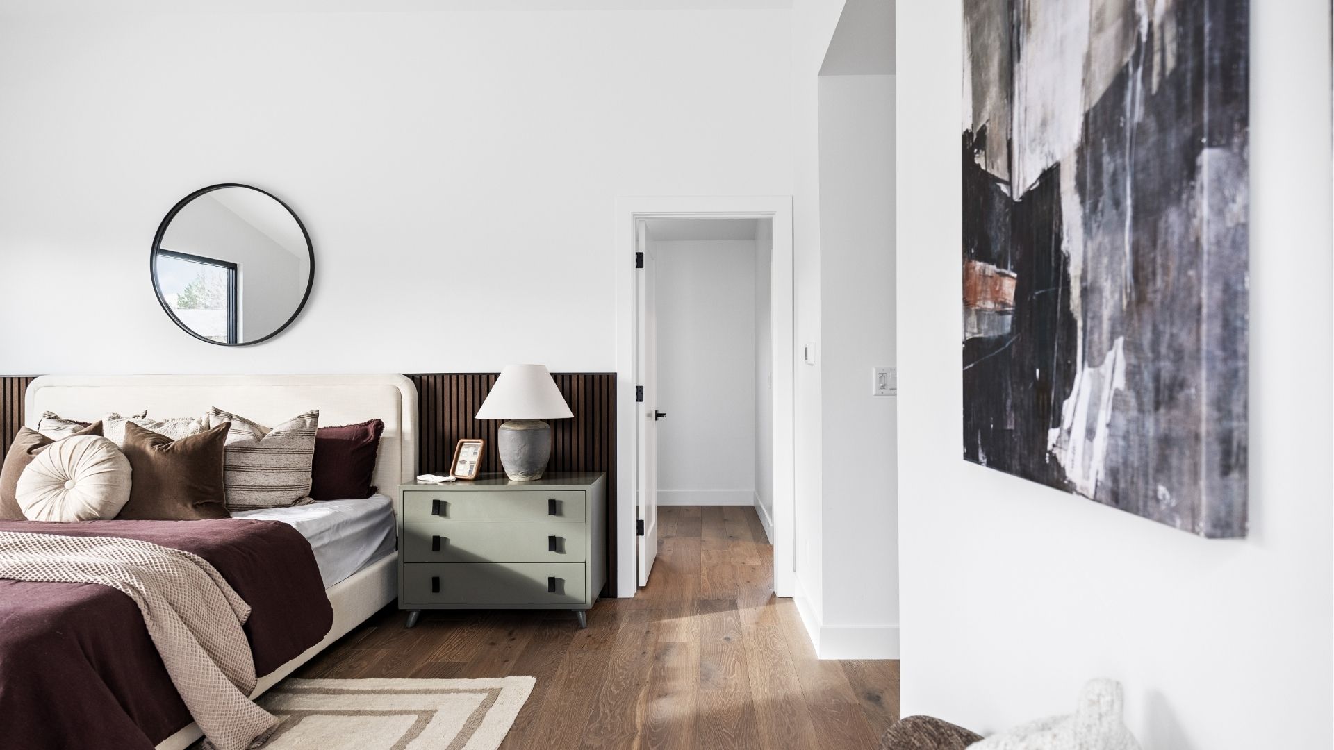 Primary suite with walk-in closet access and acupanel accent wall in Golden luxury home