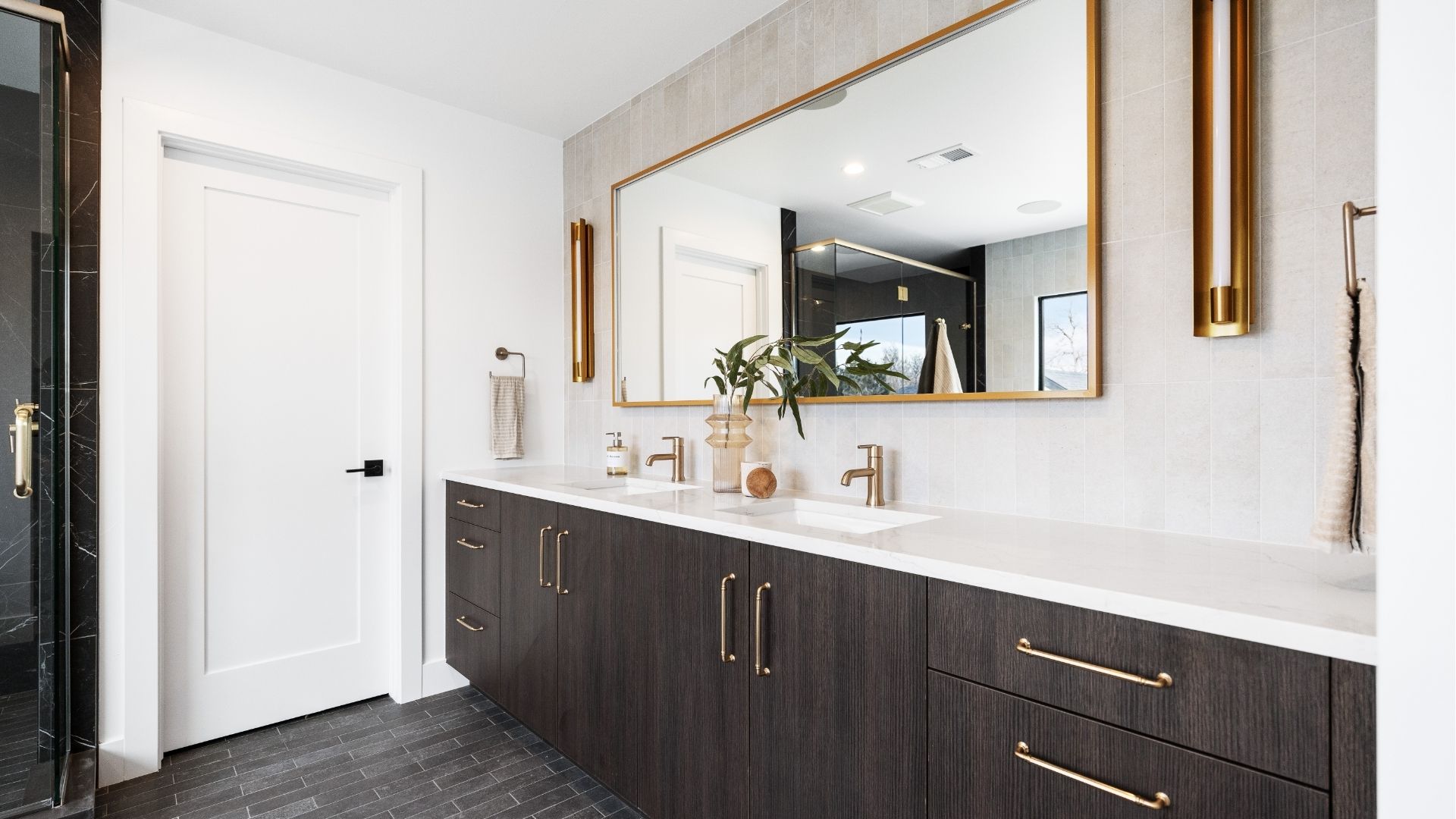 Primary bathroom with dual vanity and gold fixtures in new construction Applewood West home