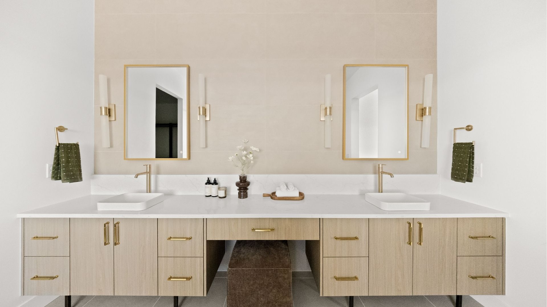 Double sink vanity with gold fixtures and makeup station in Castle Rock primary bathroom