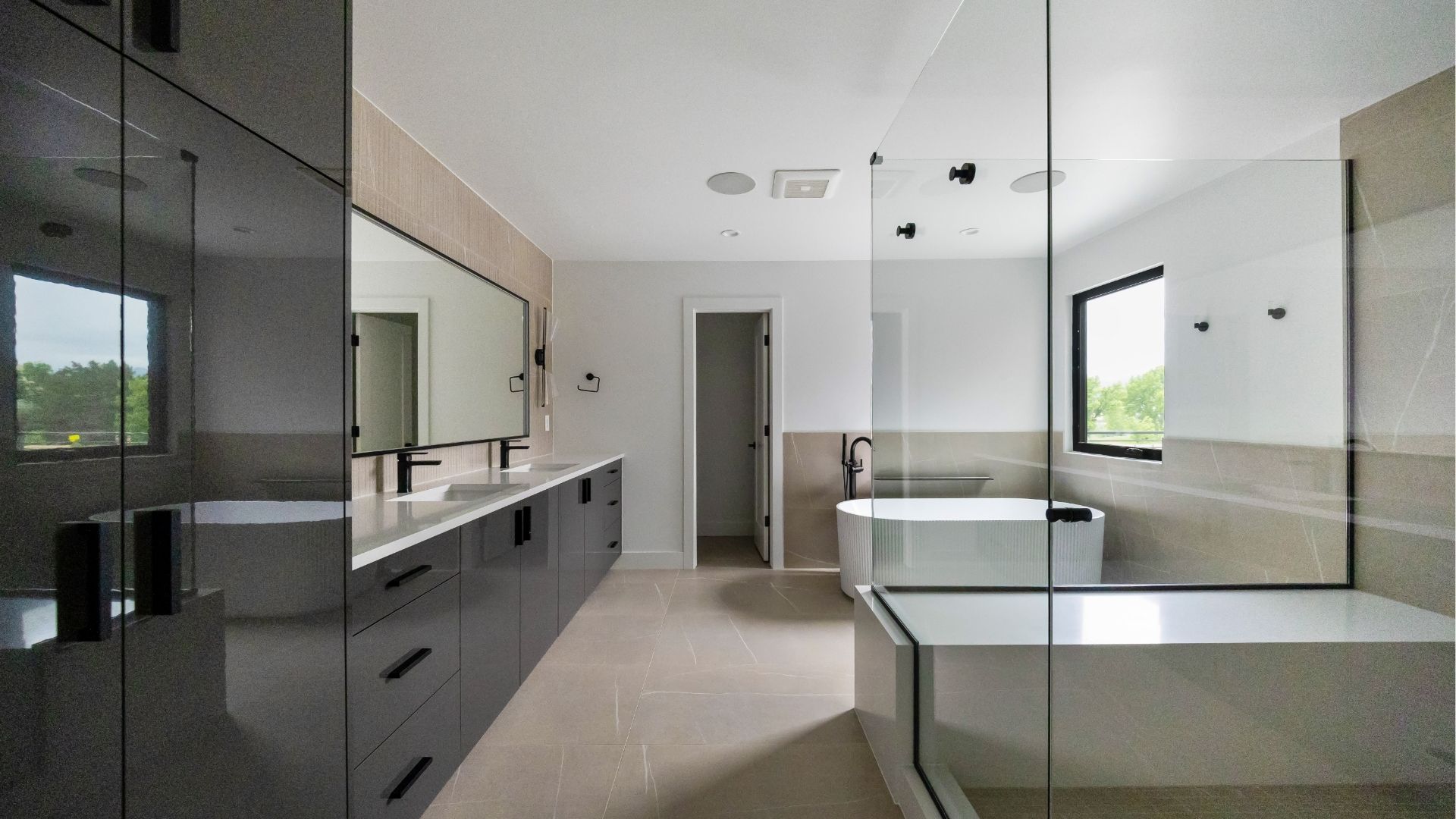 Five-piece primary bathroom with dual vanities and glass shower in luxury Golden Colorado home