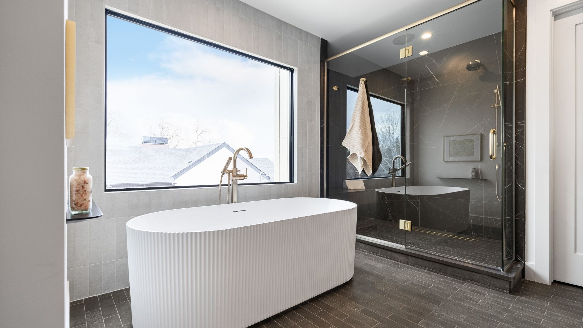 Primary bathroom with freestanding tub and quartz shower in Applewood West luxury home