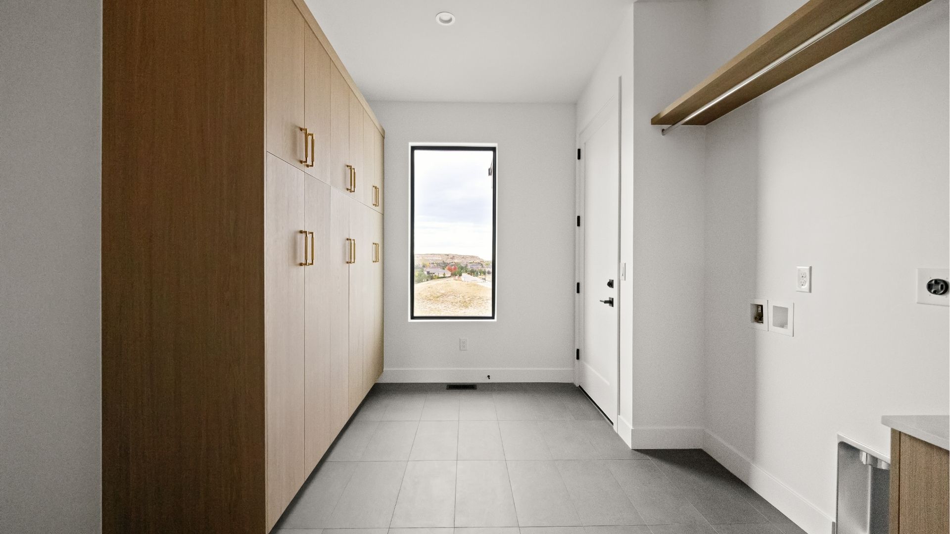 Laundry room with custom cabinetry and mudroom storage in Castle Rock luxury ranch