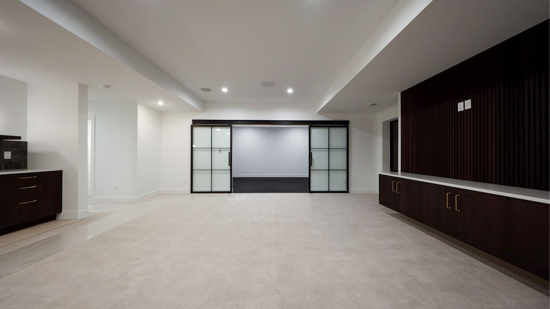 Finished basement with home gym and custom steel partition in Golden luxury home