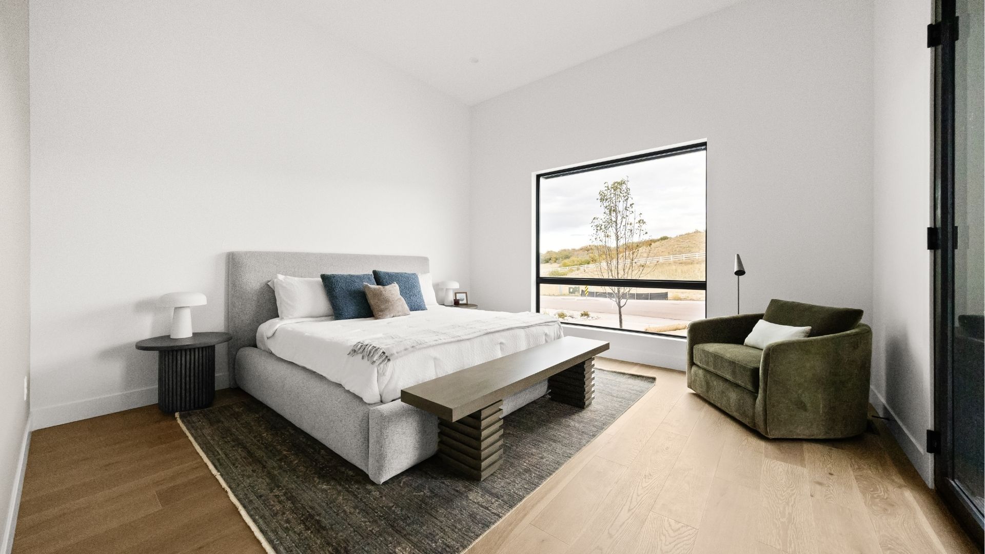 Junior suite bedroom with picture window views in Castle Rock main-level ranch home