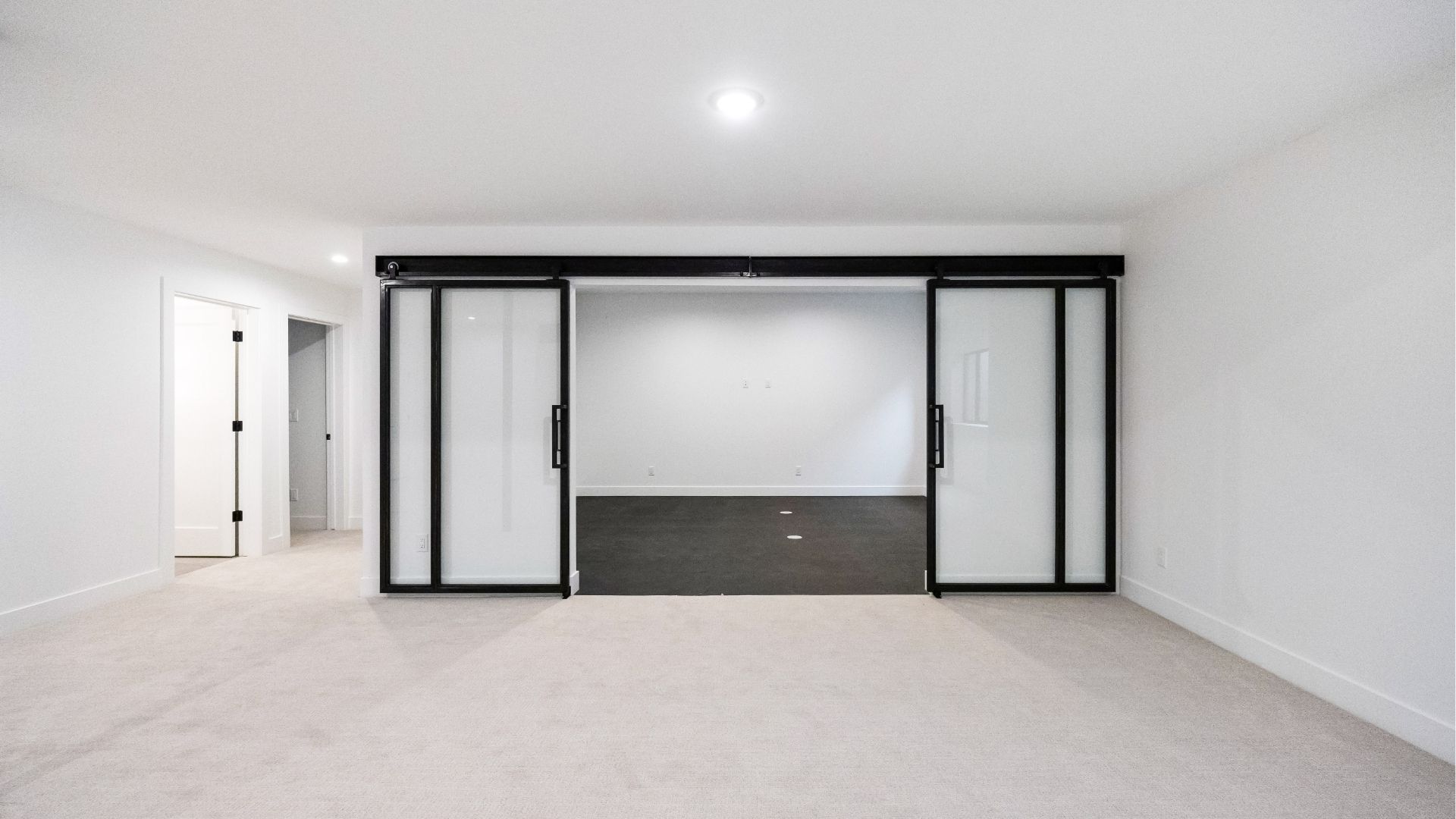 Finished basement with custom steel glass partition and gym flooring in Golden Colorado home