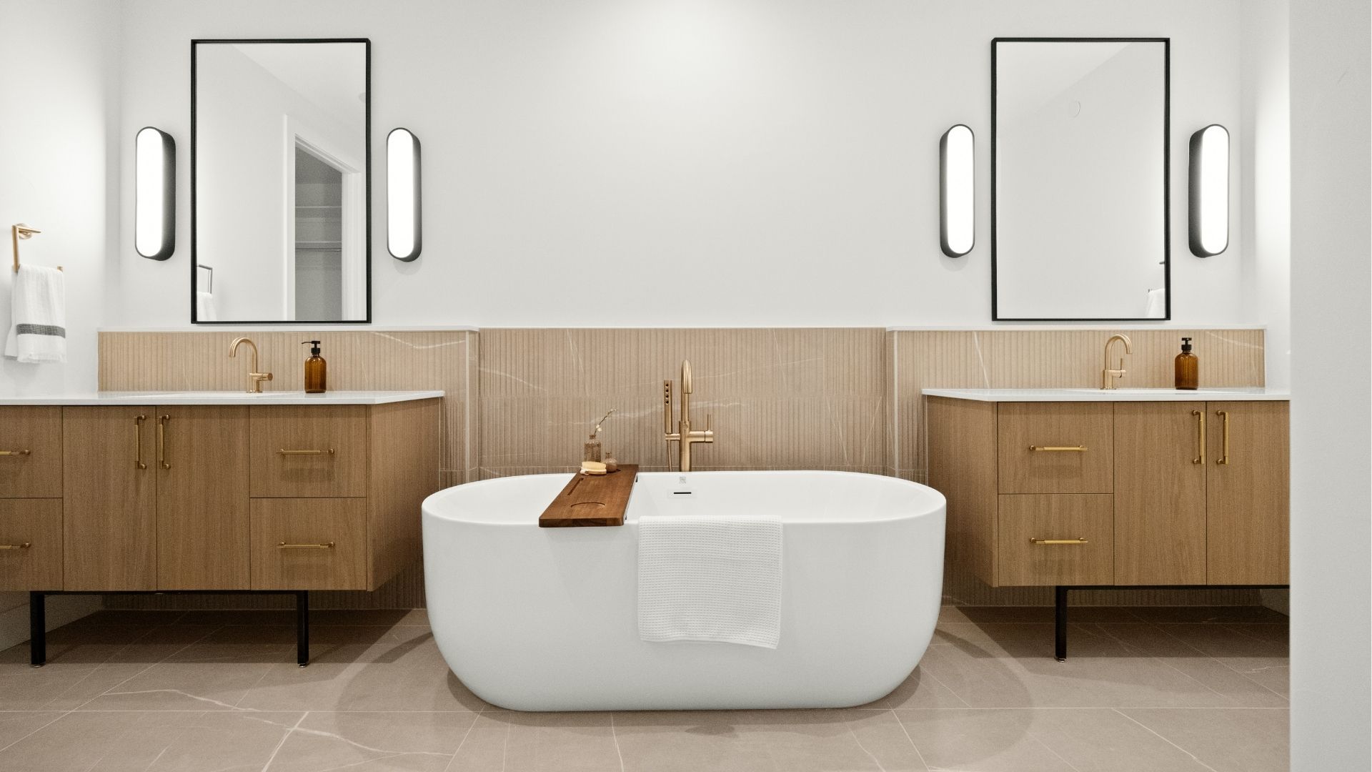 Junior suite bathroom with dual vanities and freestanding tub in Castle Rock ranch home