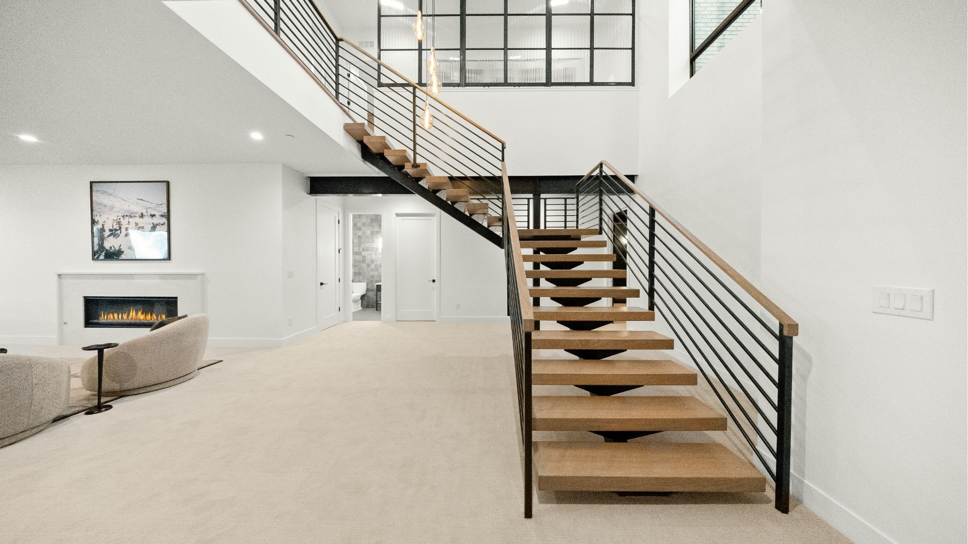 Custom floating wood staircase with steel railings in Castle Rock finished basement