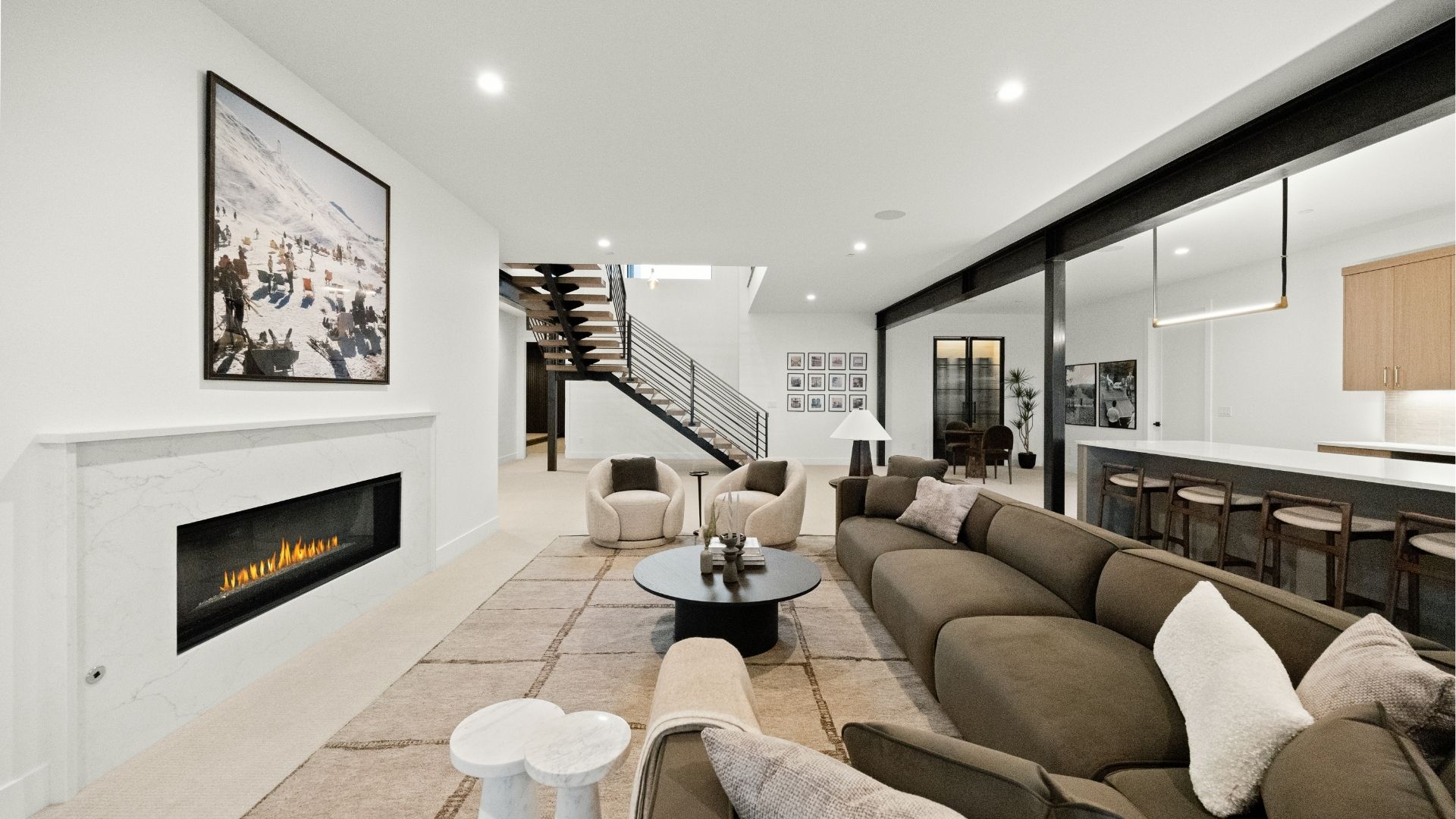 Finished basement with floating staircase, theatre room, gym and wet bar in Castle Rock luxury ranch home