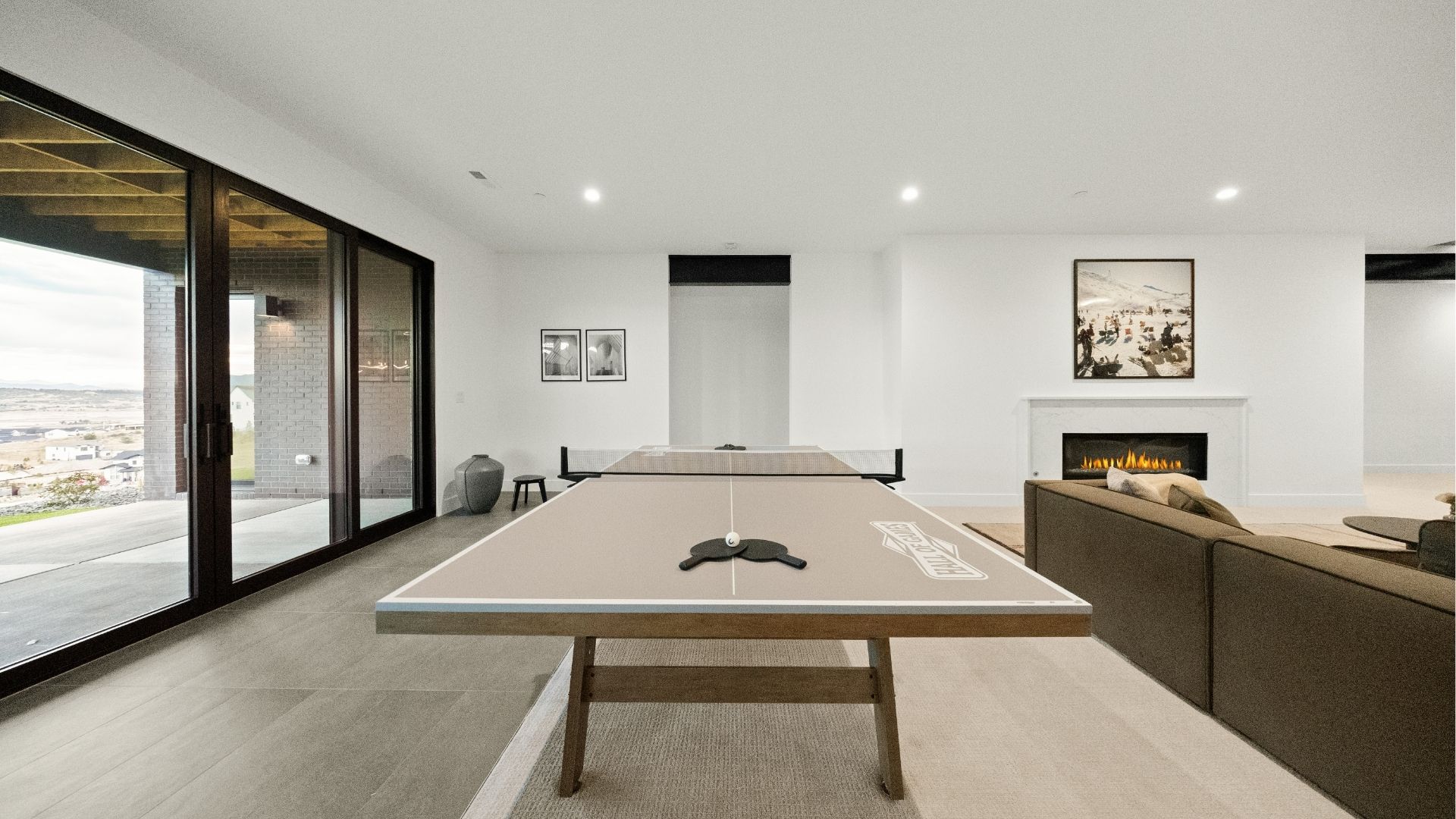 Basement game room with walkout access and fireplace in Castle Rock luxury ranch home