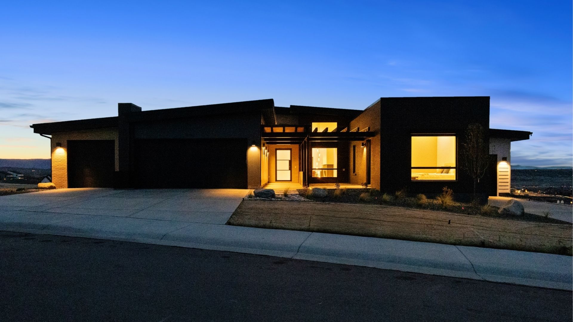Modern ranch front exterior at twilight in Castle Rock Signature at Crystal Valley