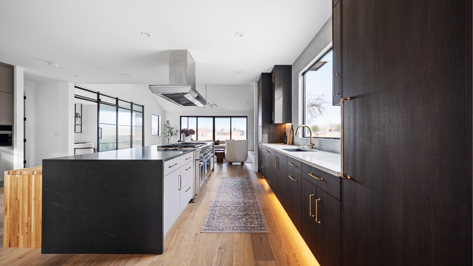 Chef's kitchen with eating islands and under-cabinet lighting in new construction Golden home