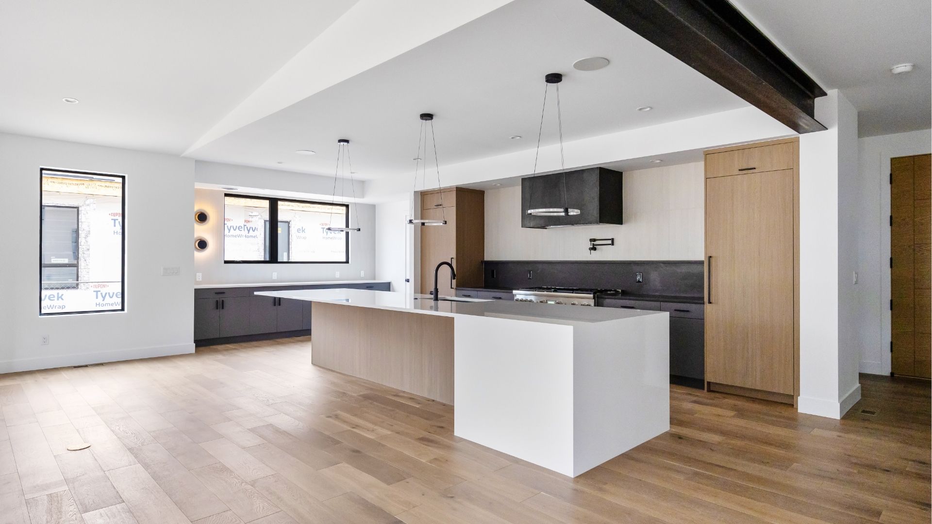 Luxury kitchen with custom steel beam and designer lighting in contemporary Golden Colorado home