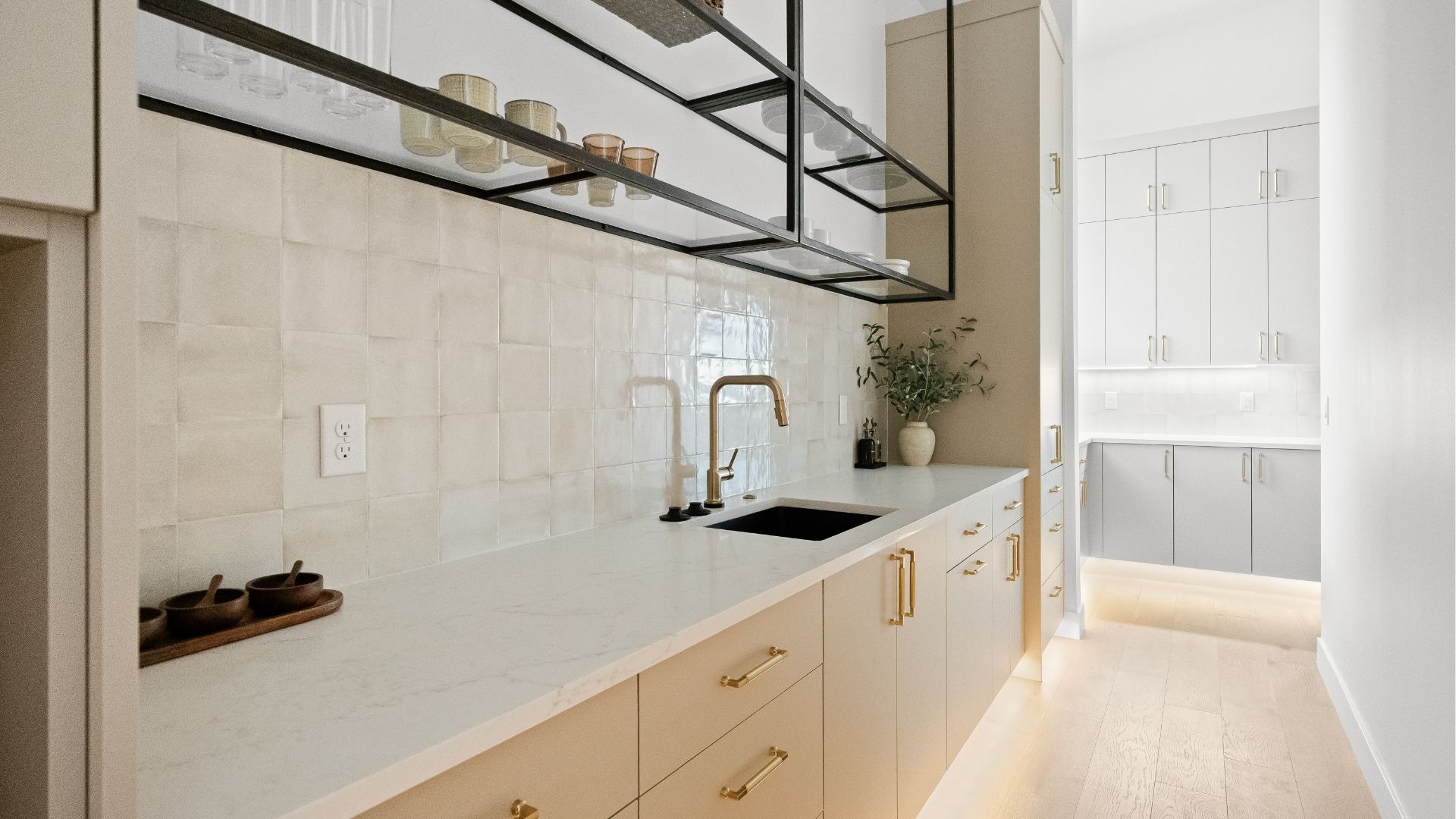 Butler's pantry with steel glass shelving and tile backsplash in Castle Rock luxury home