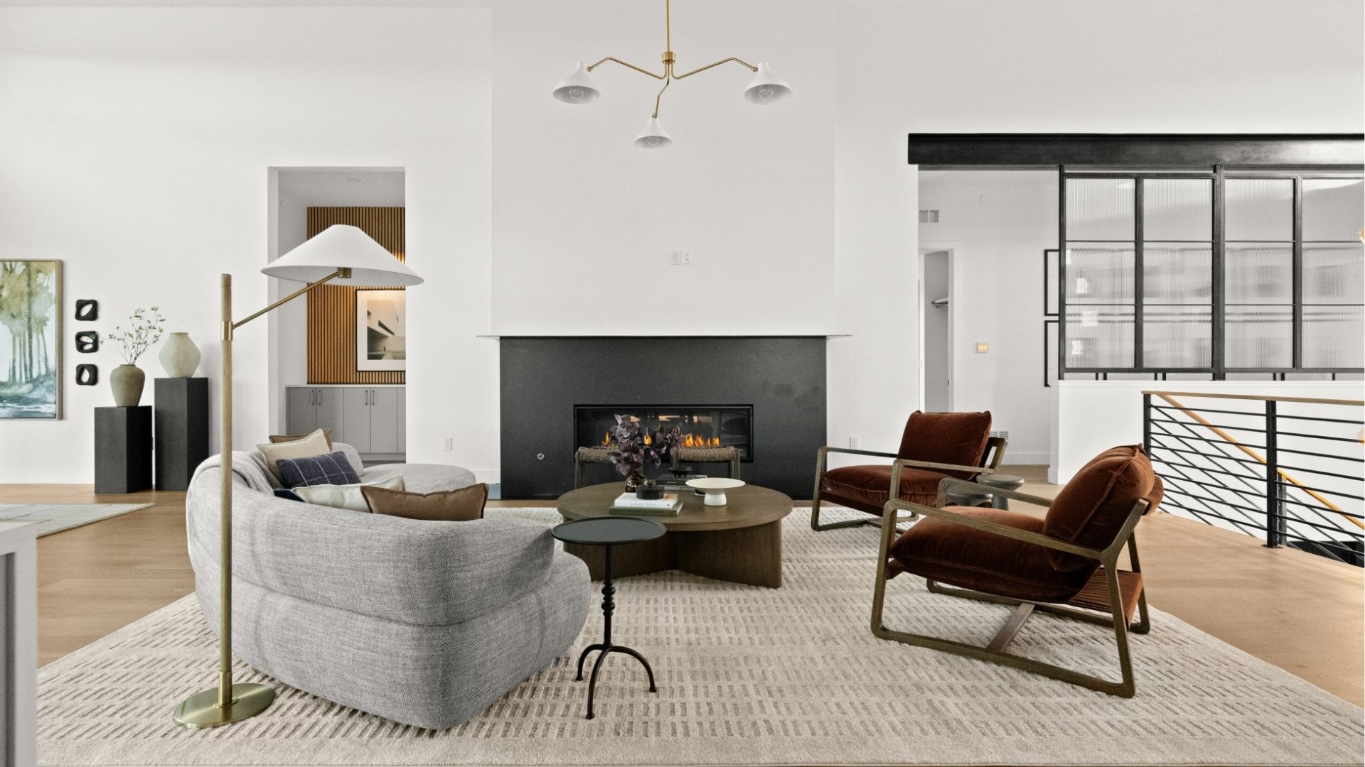 Living room with vaulted ceiling and linear fireplace in Castle Rock modern ranch home