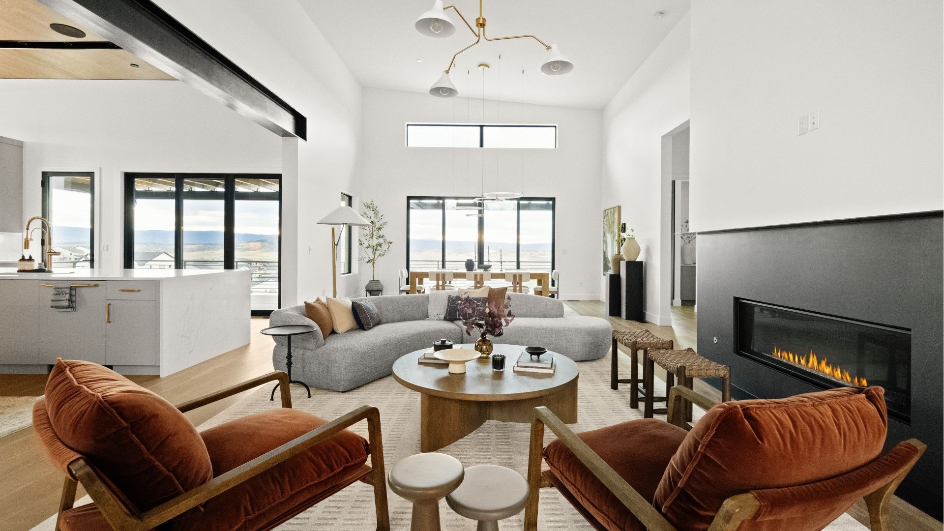 Open-concept living area with vaulted ceiling and panoramic mountain views in Castle Rock ranch