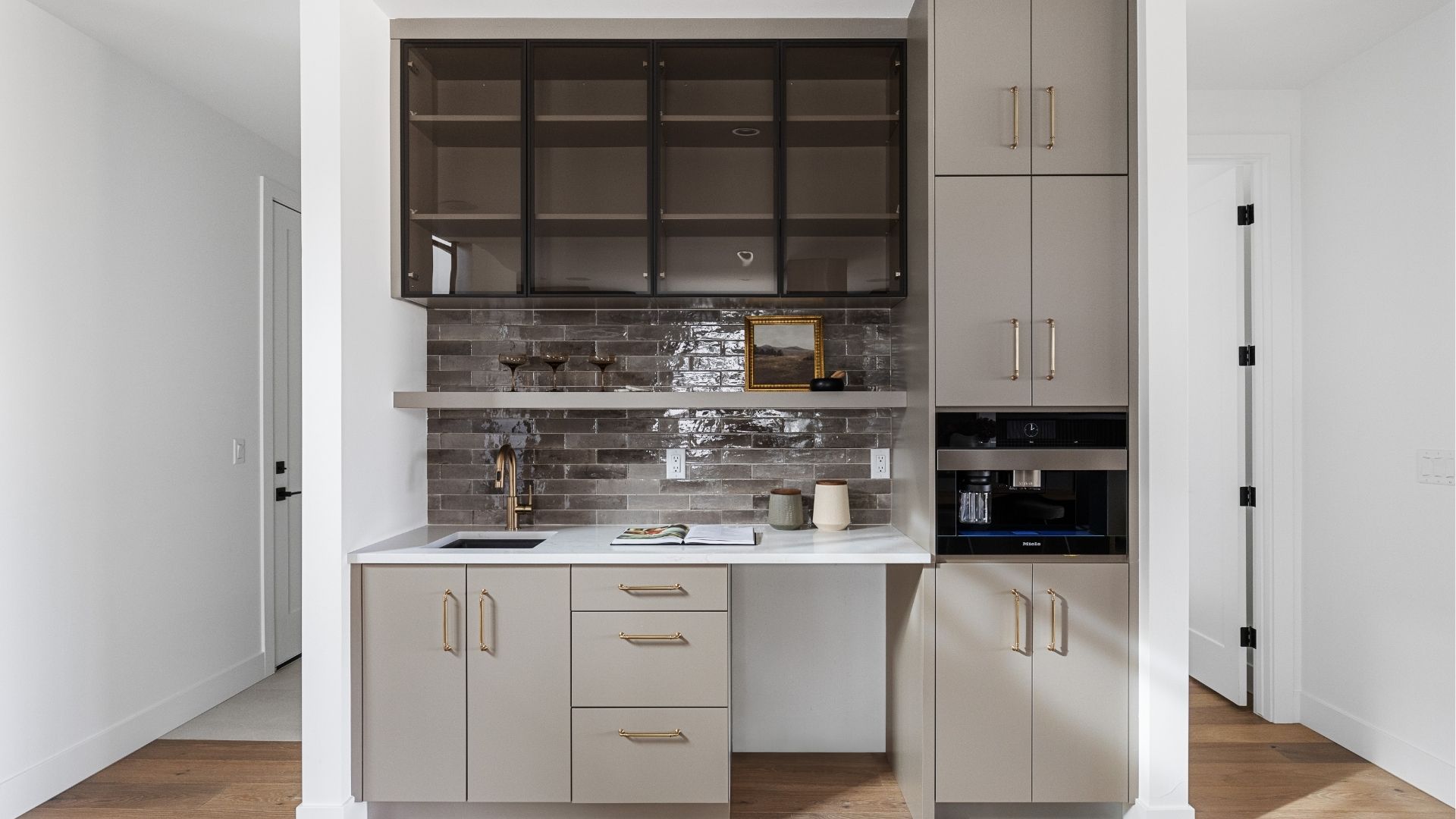 Wet bar with glass-front cabinets and tile backsplash in luxury Golden home