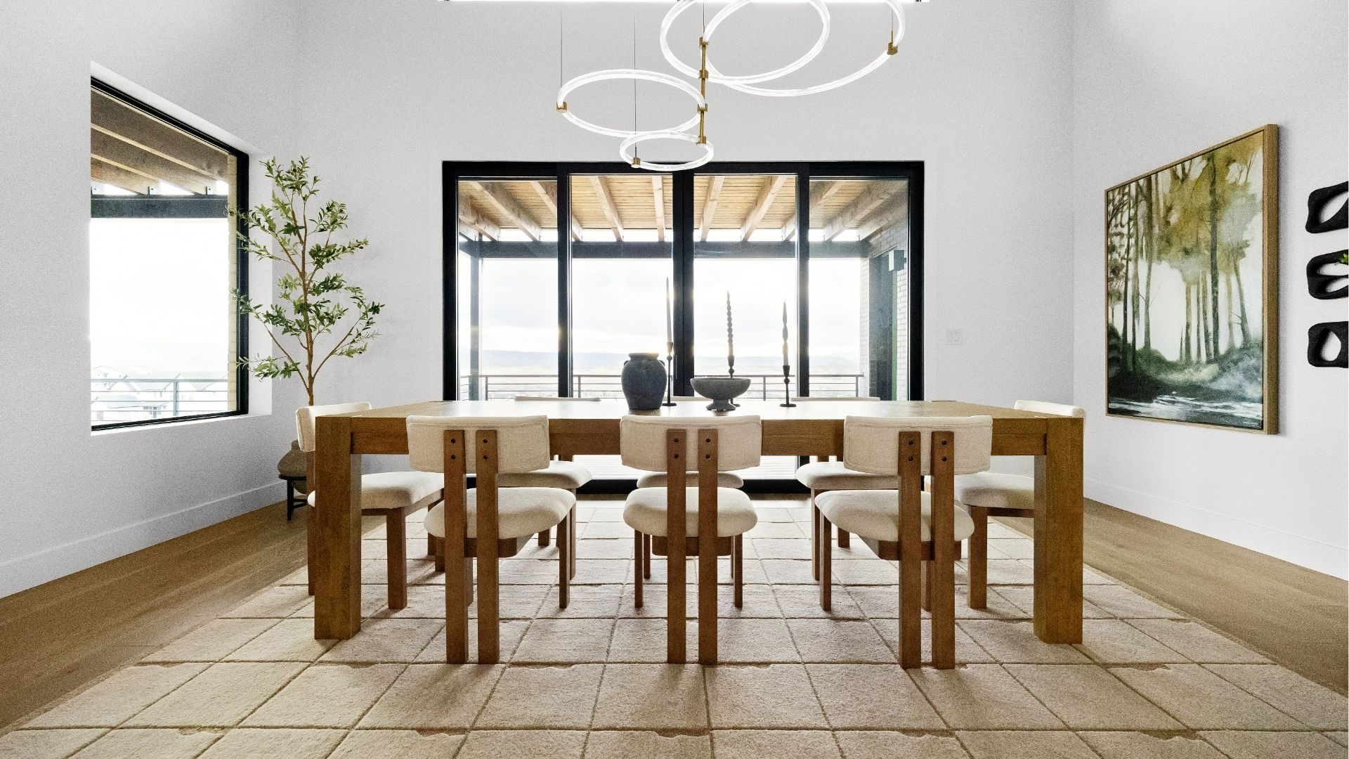 Dining room with panoramic views and designer lighting in Castle Rock luxury ranch home