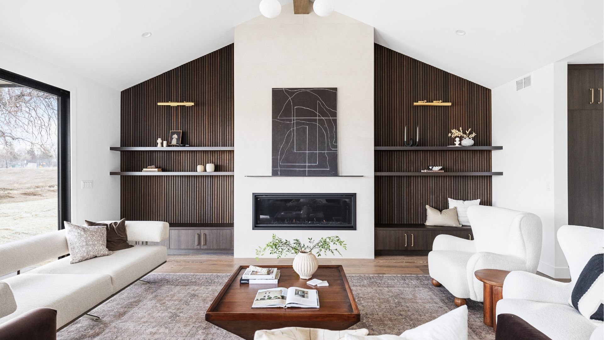 Contemporary living room with fireplace and custom textured shelving in Golden luxury home
