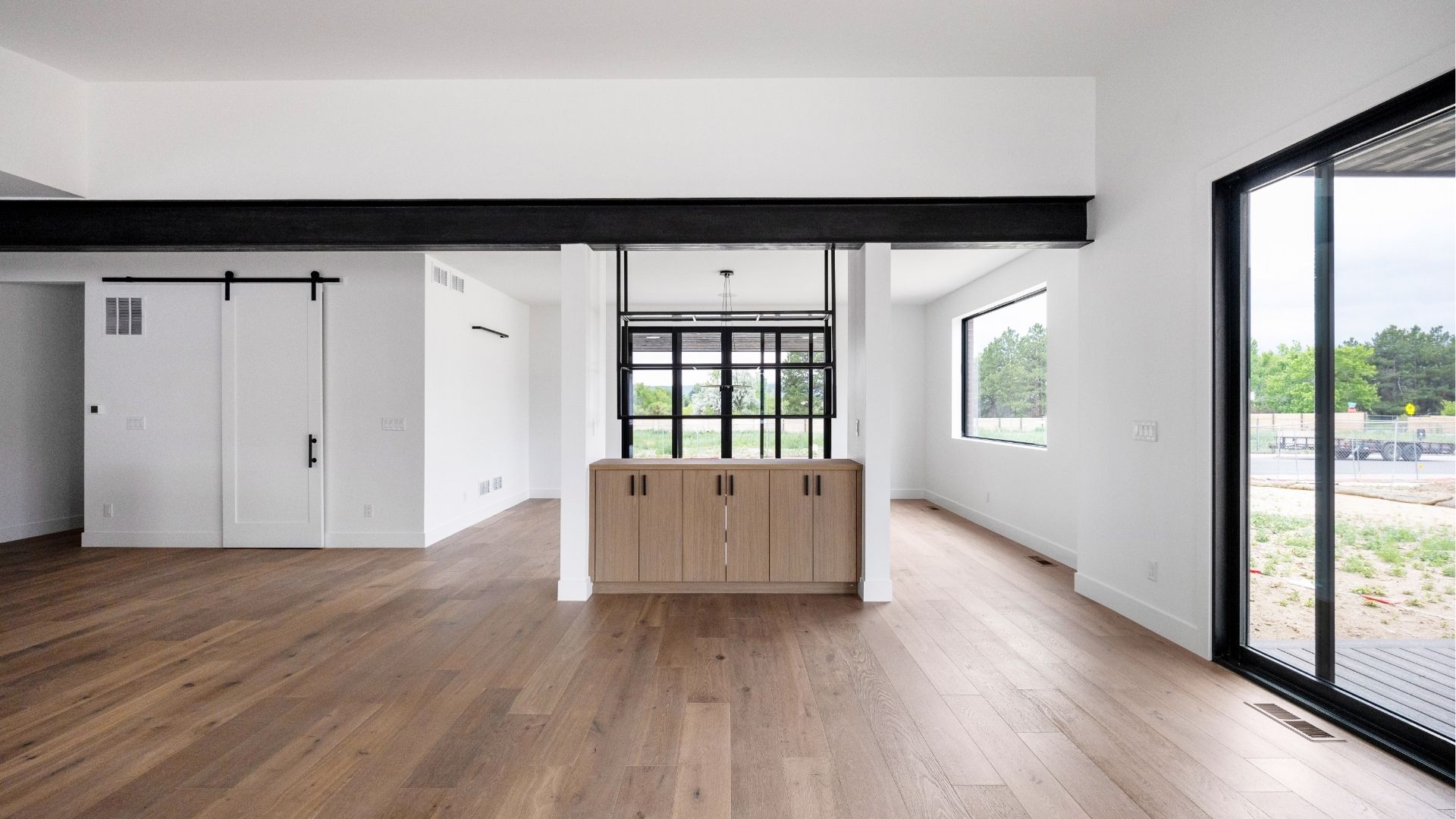 Custom dining room partition with iron shelving and wood cabinetry in Golden Colorado luxury home