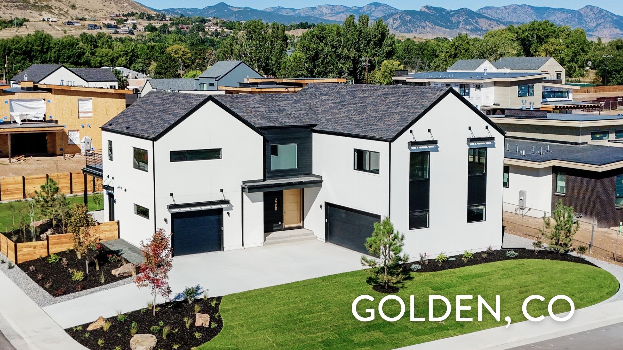Contemporary luxury home exterior at 5031 Moss Place in Golden, CO featuring white stucco, black accents, and mountain views