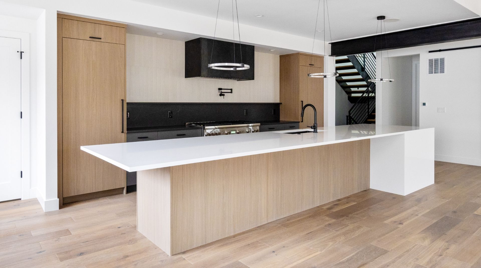 Eat-in kitchen with large island and custom barn door in move-in ready Golden luxury home