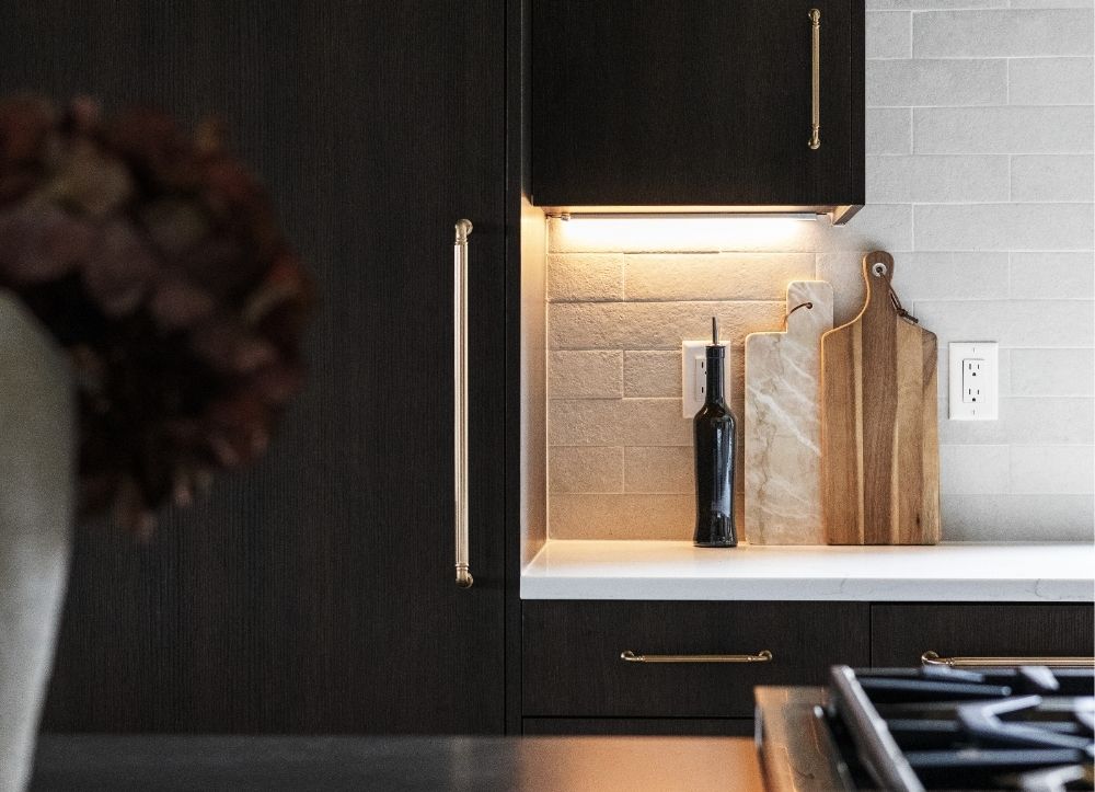 Kitchen Detail with Custom Lighting | Applewood West Custom kitchen cabinetry with under-cabinet lighting and designer hardware in Golden luxury home