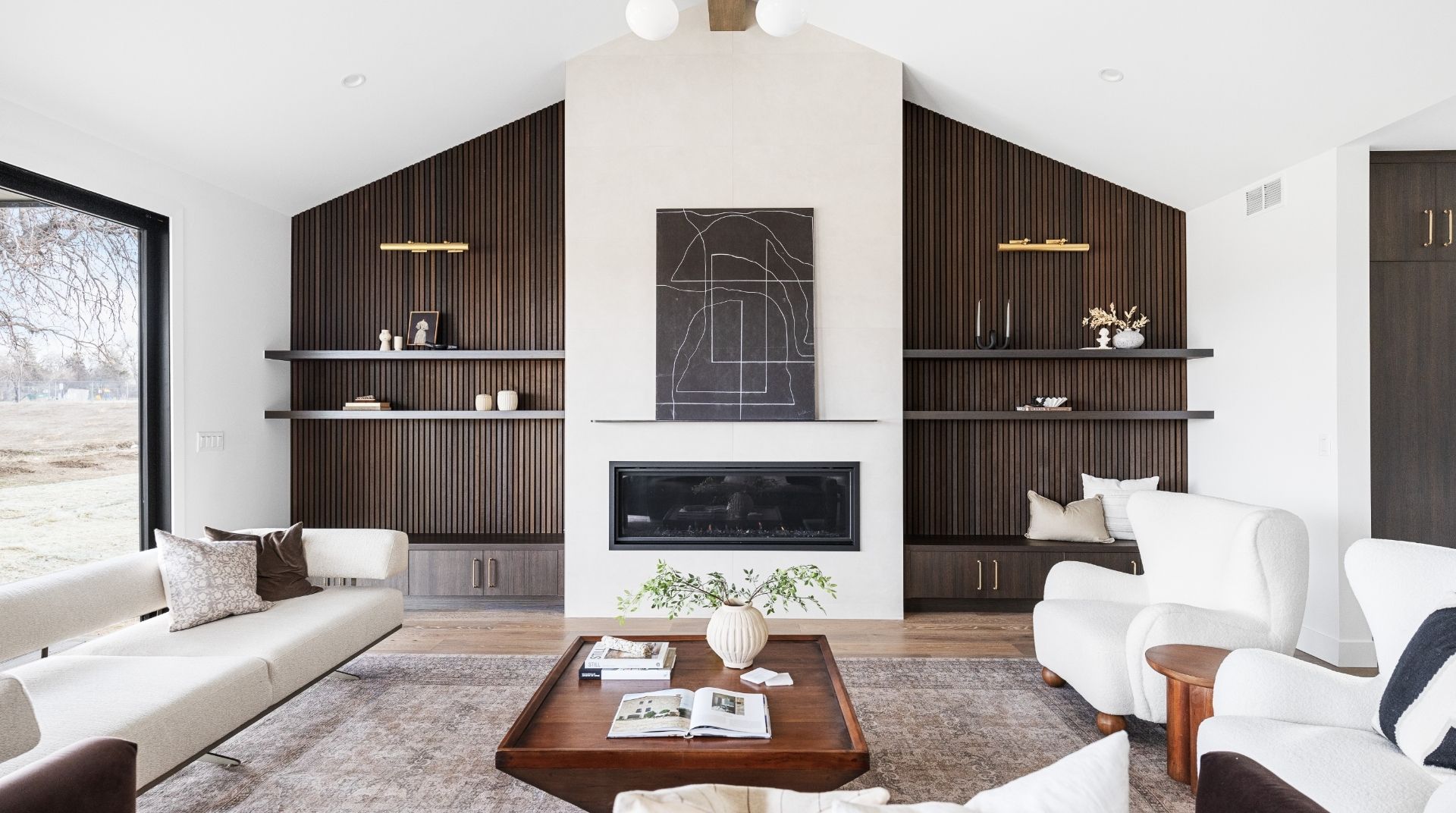 Contemporary living room with fireplace and custom textured shelving in Golden luxury home
