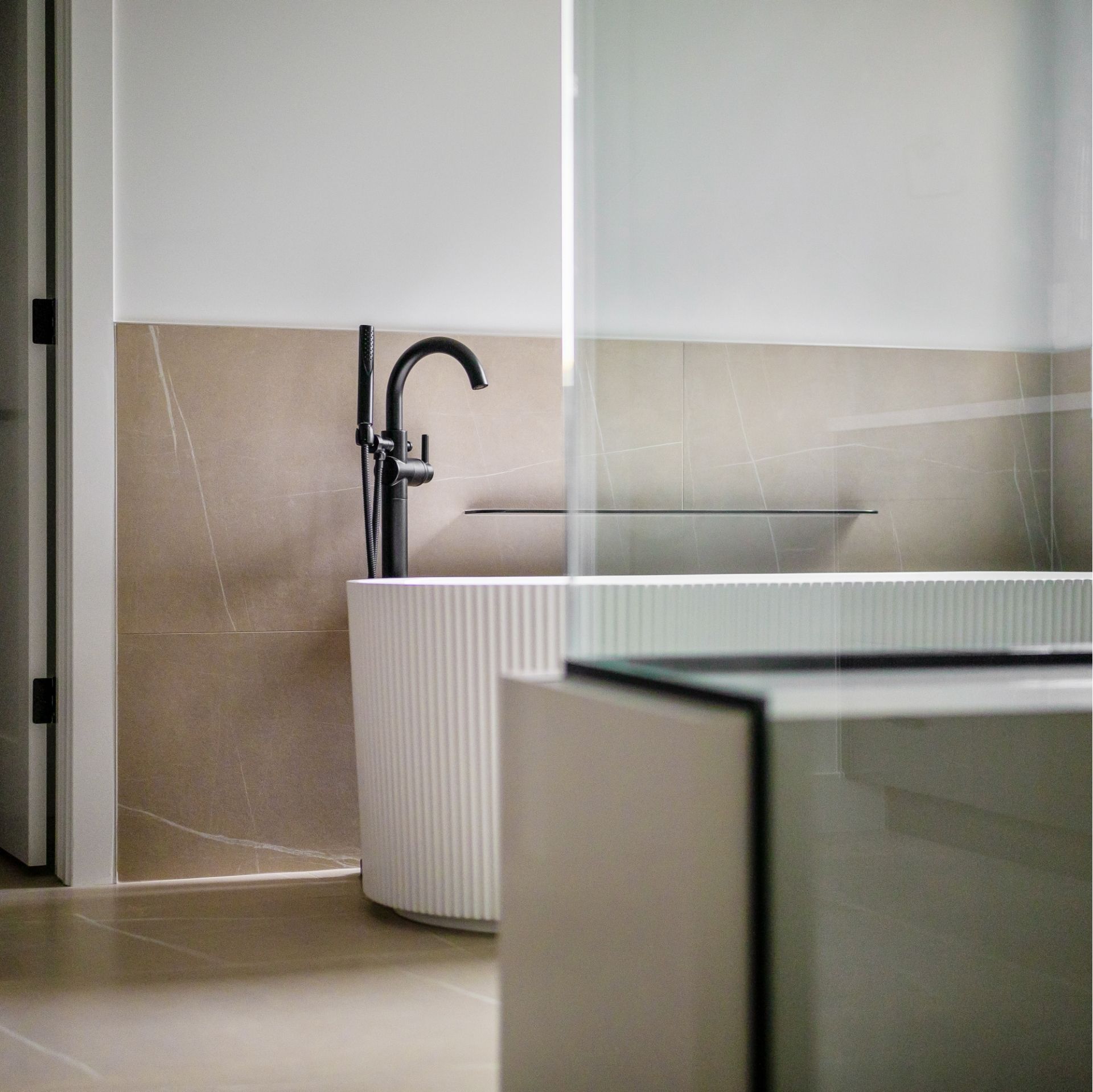 Luxury spa bathroom with freestanding soaking tub and designer fixtures in Golden Colorado custom home