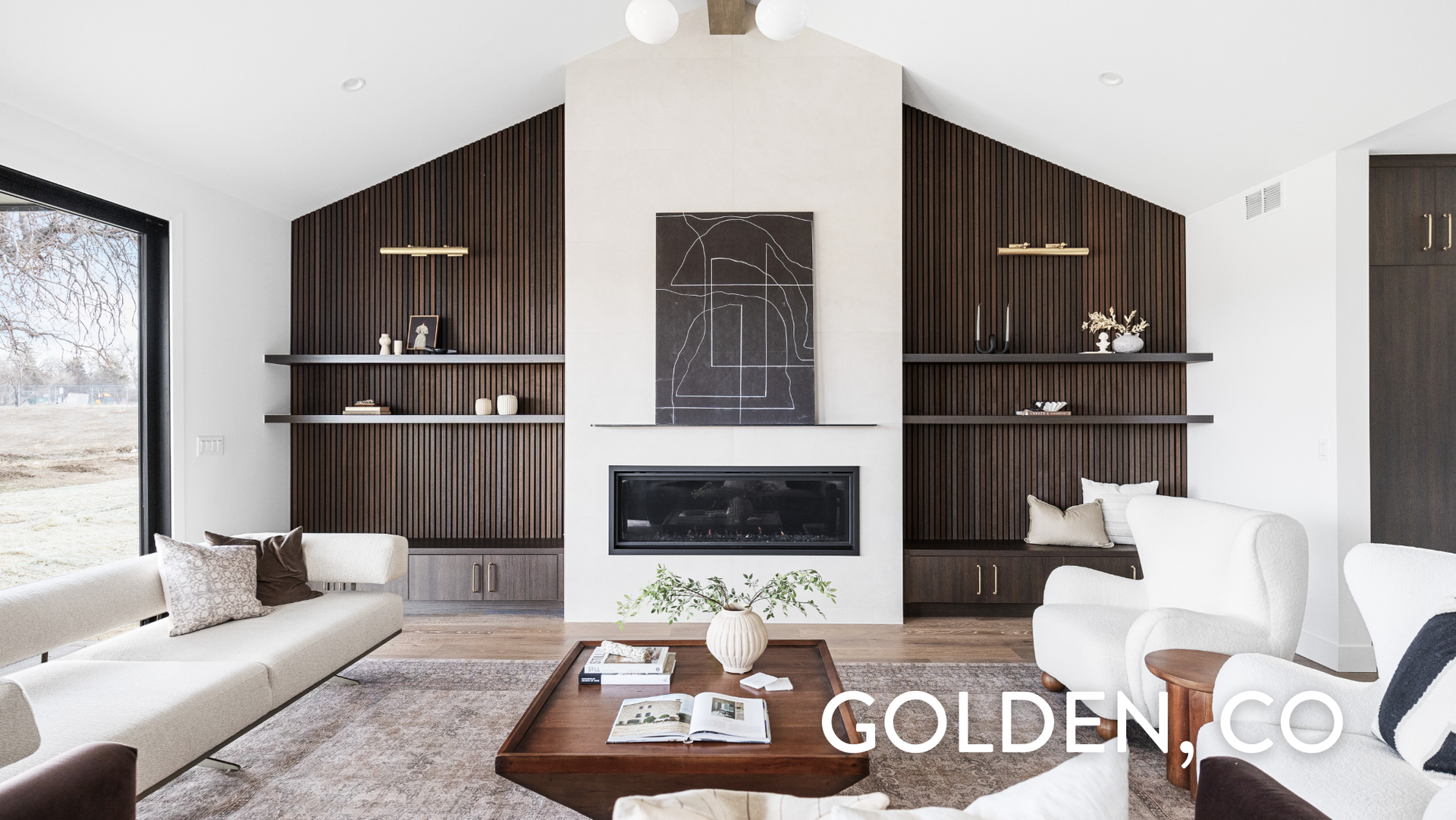 Contemporary living room with fireplace and custom textured shelving in Golden luxury home