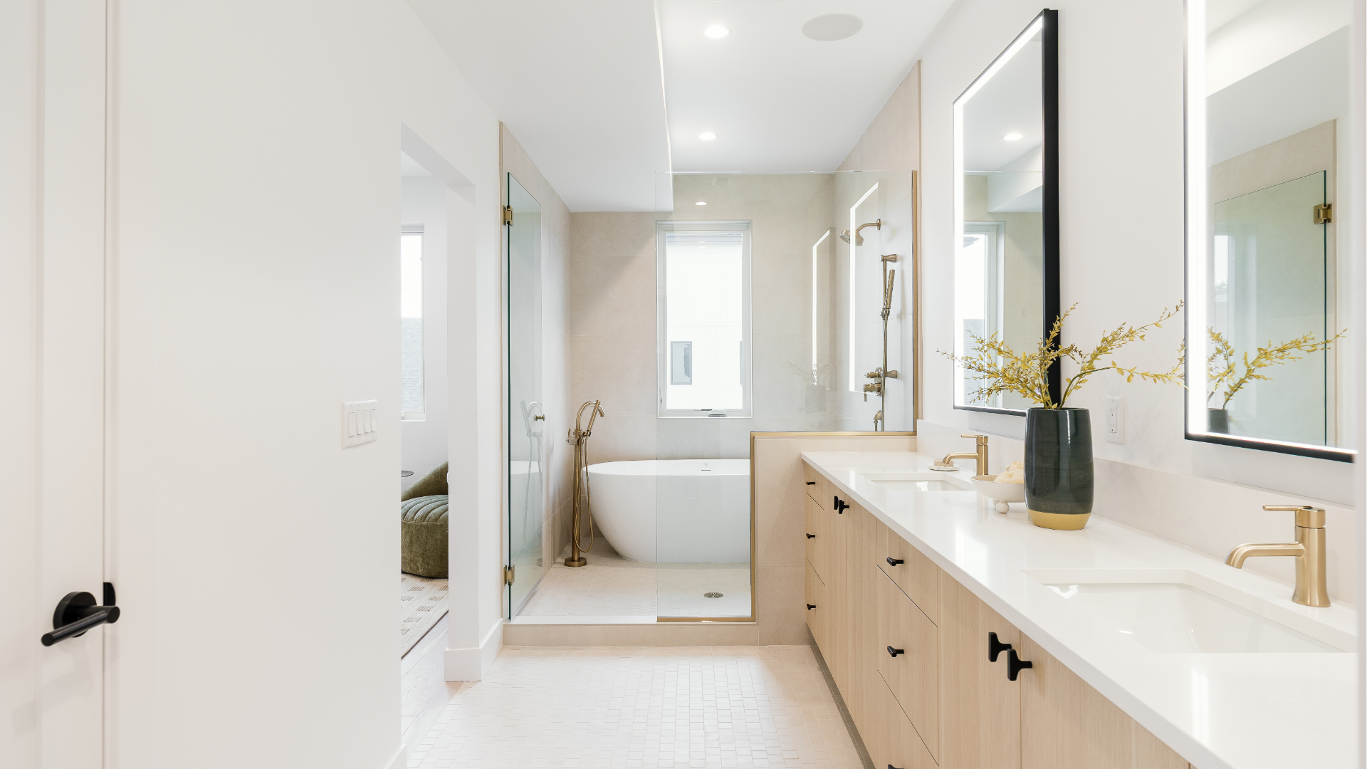 Primary bathroom with freestanding soaking tub, glass walk-in shower, and double vanity with backlit mirrors